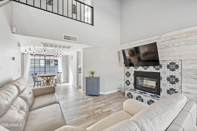 living room featuring light hardwood / wood-style floors and a high ceiling