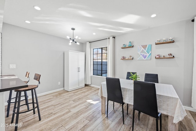 dining area featuring a notable chandelier and light hardwood / wood-style flooring