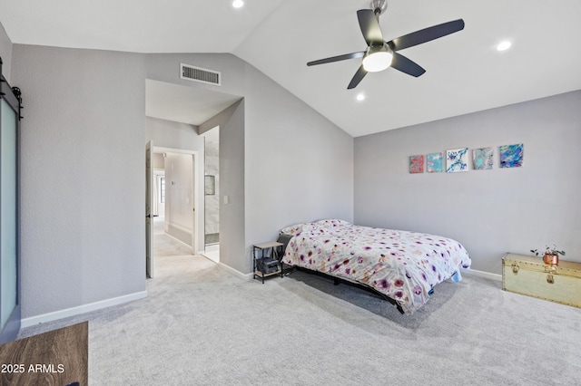 bedroom featuring vaulted ceiling, a barn door, light carpet, and ceiling fan