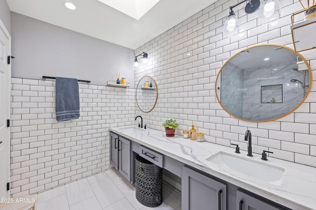 bathroom featuring vanity, tile walls, and a shower