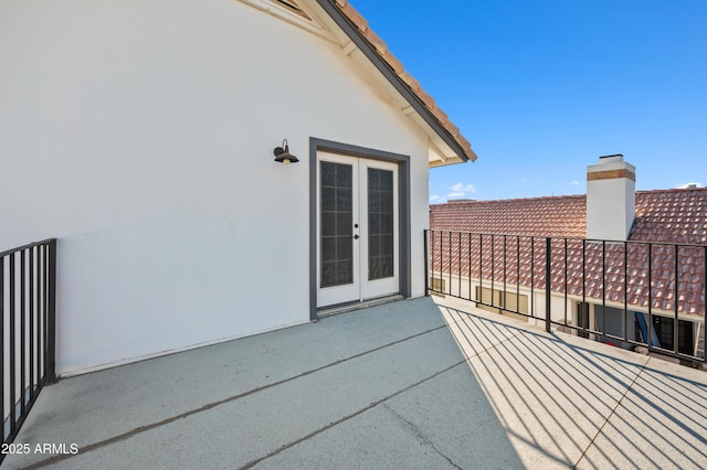 view of patio featuring a balcony and french doors