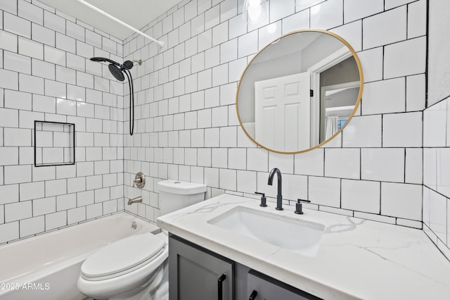 full bathroom with tile walls, decorative backsplash, tiled shower / bath combo, vanity, and toilet