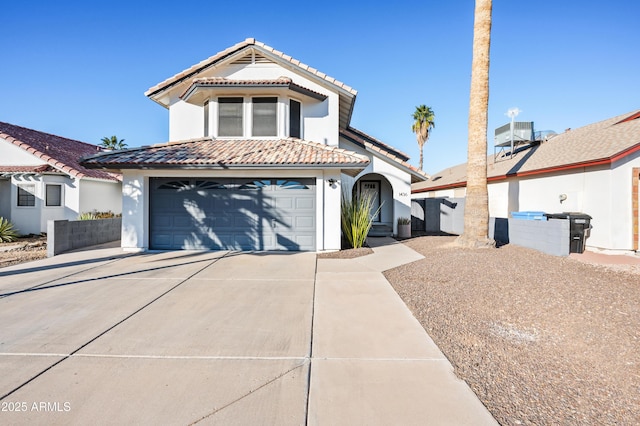 view of front of home with central AC unit and a garage