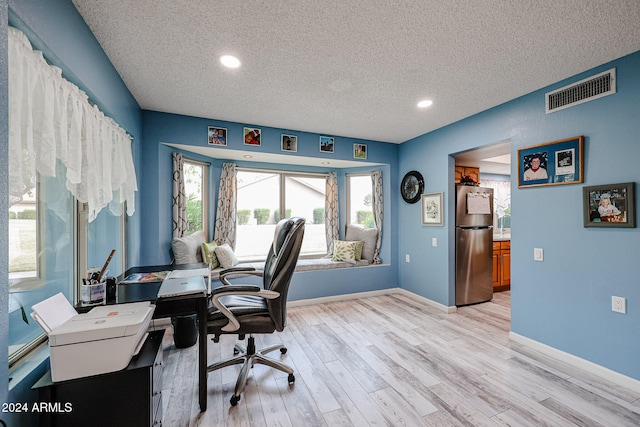 office featuring a textured ceiling and light wood-type flooring