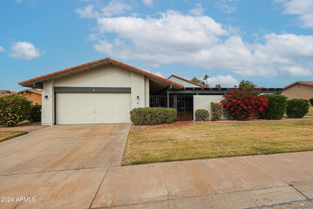 view of front facade with a front lawn and a garage