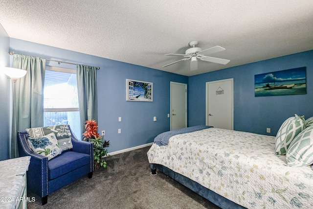 bedroom featuring ceiling fan, a textured ceiling, and dark colored carpet