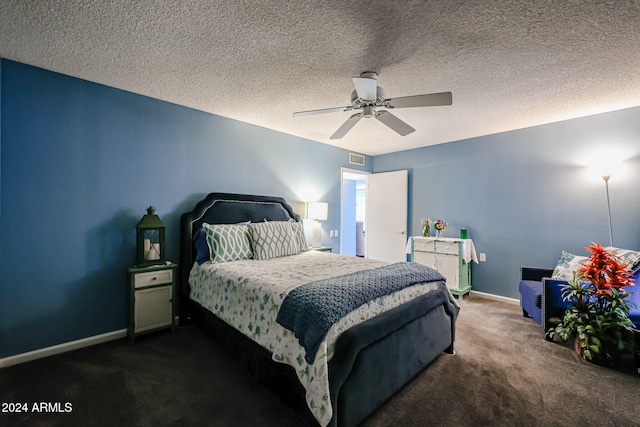 carpeted bedroom featuring a textured ceiling and ceiling fan