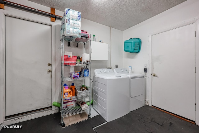 washroom featuring washer and dryer and a textured ceiling