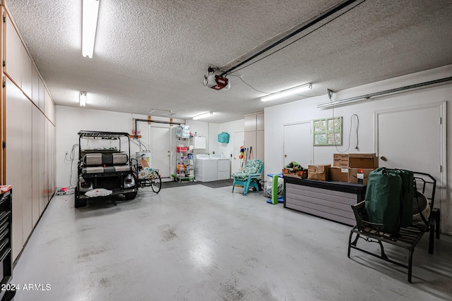 garage with washer and clothes dryer and a garage door opener