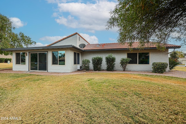 rear view of house with a lawn