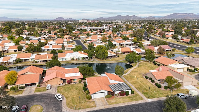 drone / aerial view featuring a water and mountain view