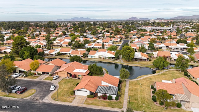 birds eye view of property featuring a water and mountain view