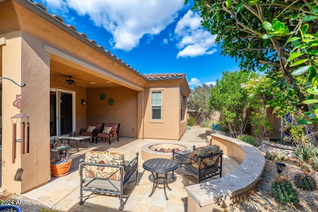 view of patio with an outdoor living space with a fire pit and ceiling fan