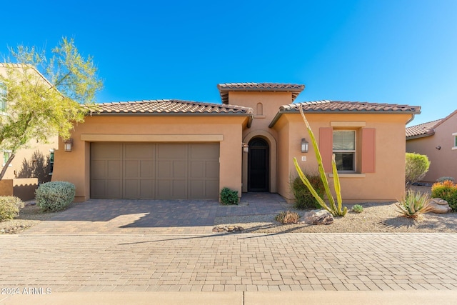 mediterranean / spanish house with a garage