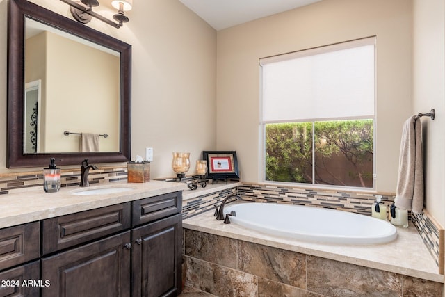 bathroom featuring vanity and tiled bath