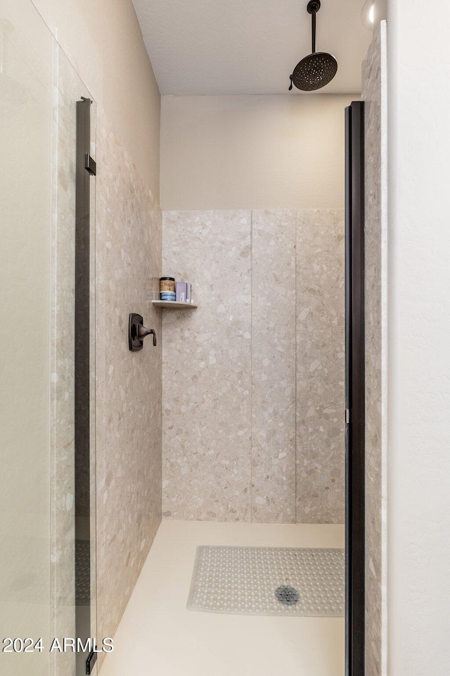 bathroom with tiled shower