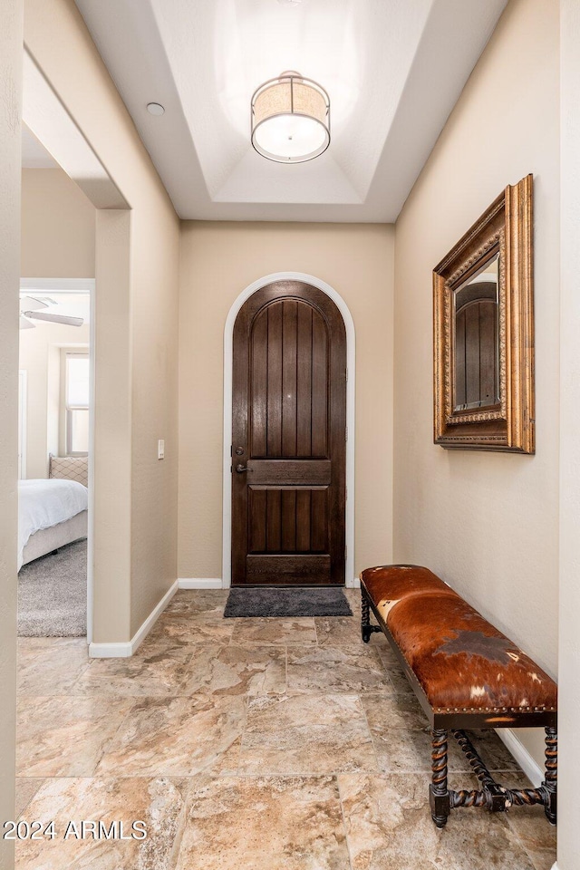 foyer featuring a raised ceiling