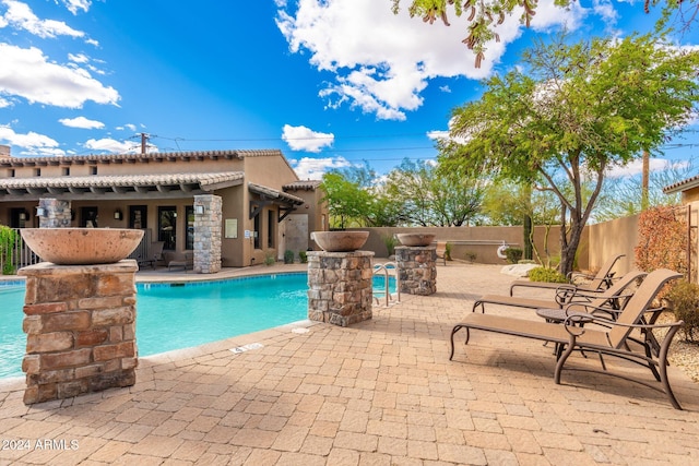 view of swimming pool with a patio area