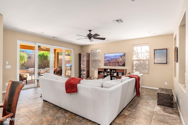 living room with ceiling fan and a healthy amount of sunlight