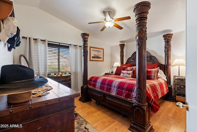 bedroom with vaulted ceiling and light hardwood / wood-style floors