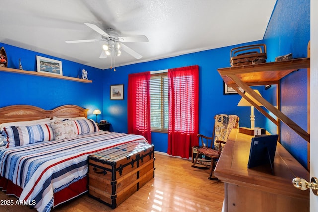 bedroom with wood-type flooring and ceiling fan