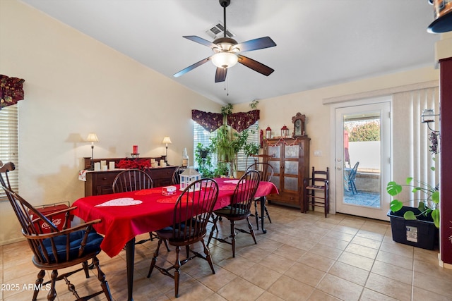 tiled dining space with vaulted ceiling and ceiling fan