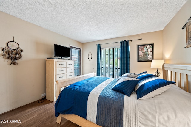 bedroom featuring a textured ceiling and hardwood / wood-style floors