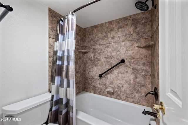 bathroom featuring shower / bath combination with curtain, a textured ceiling, and toilet