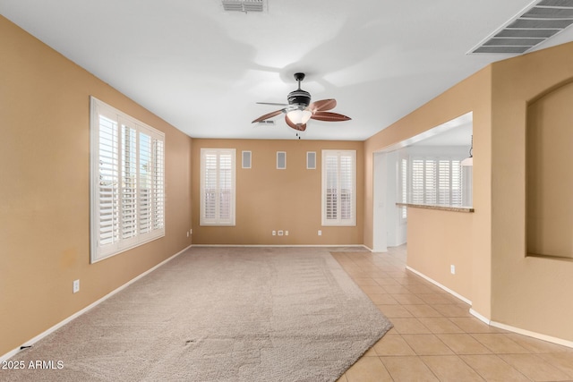 tiled empty room with ceiling fan