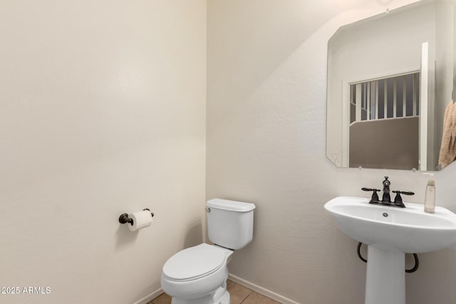 bathroom featuring toilet and tile patterned flooring