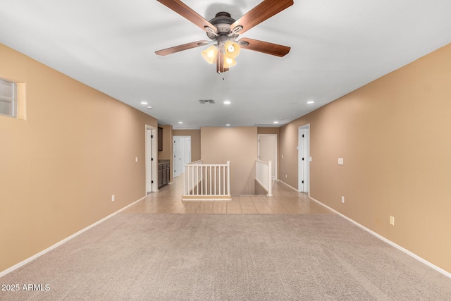 tiled spare room featuring ceiling fan