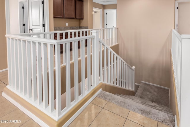 staircase featuring tile patterned flooring