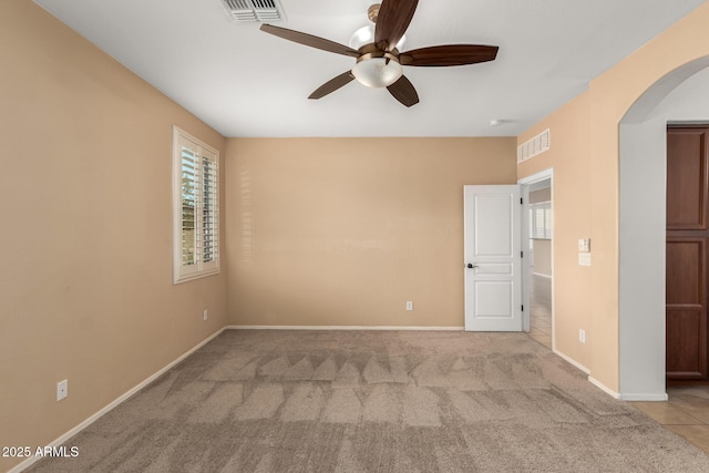 unfurnished room with ceiling fan and light colored carpet