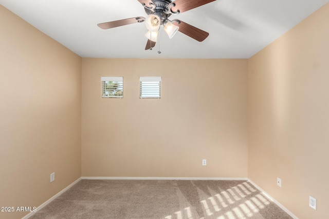 spare room featuring ceiling fan and carpet flooring