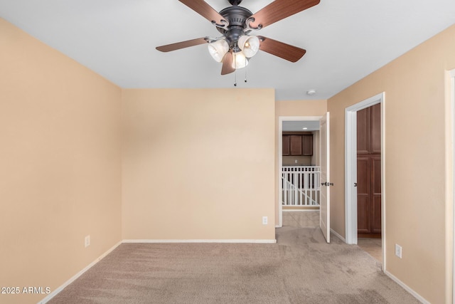 carpeted empty room with ceiling fan