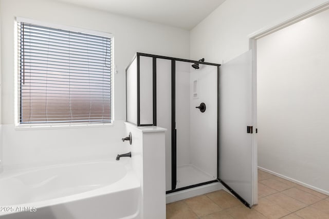 bathroom featuring tile patterned flooring and shower with separate bathtub