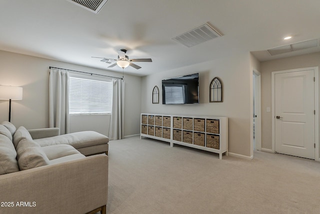 carpeted living room with baseboards, a ceiling fan, and visible vents