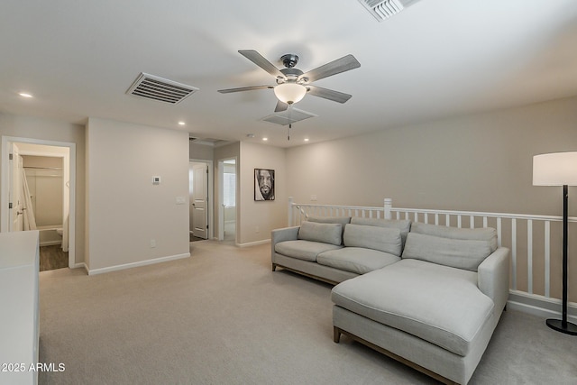 living room with a ceiling fan, visible vents, recessed lighting, and light colored carpet