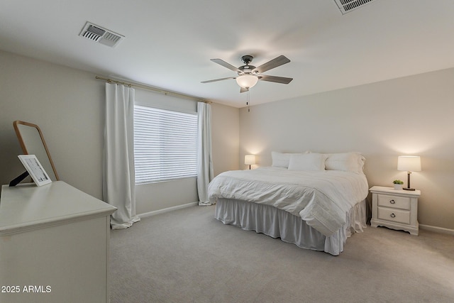 bedroom featuring baseboards, visible vents, light colored carpet, and ceiling fan