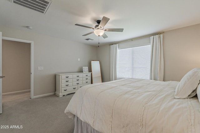 bedroom featuring baseboards, visible vents, light colored carpet, and ceiling fan