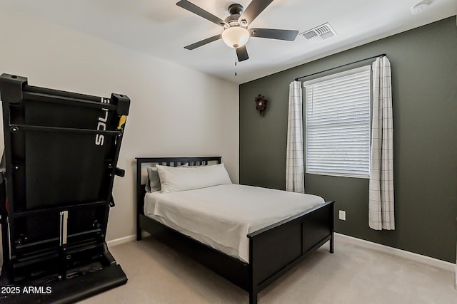 bedroom with baseboards, visible vents, light colored carpet, and ceiling fan
