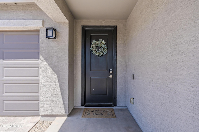 property entrance featuring stucco siding