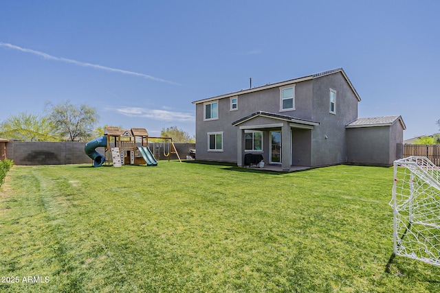 back of property featuring stucco siding, a lawn, a fenced backyard, and a playground