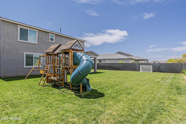 view of playground with fence and a yard