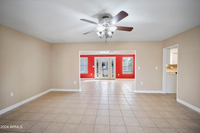 unfurnished room with french doors, a textured ceiling, ceiling fan, and light tile patterned floors