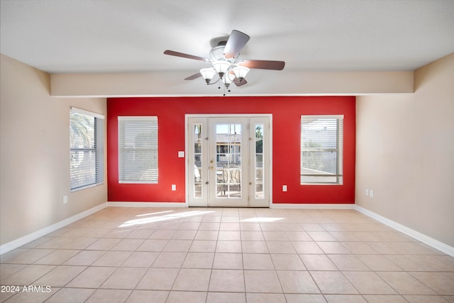 interior space with ceiling fan and light tile patterned flooring