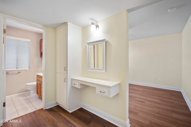 bathroom featuring toilet, hardwood / wood-style flooring, and vanity