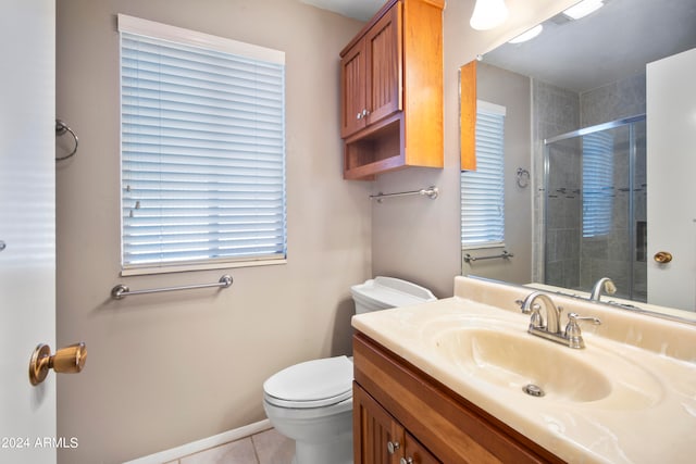 bathroom with vanity, tile patterned floors, toilet, and an enclosed shower