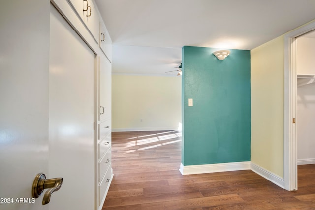 hallway with hardwood / wood-style flooring