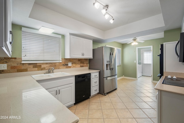 kitchen with black dishwasher, a raised ceiling, sink, and white cabinets